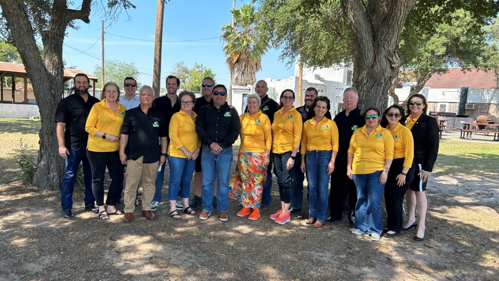 Group of people wearing yellow shirts under trees