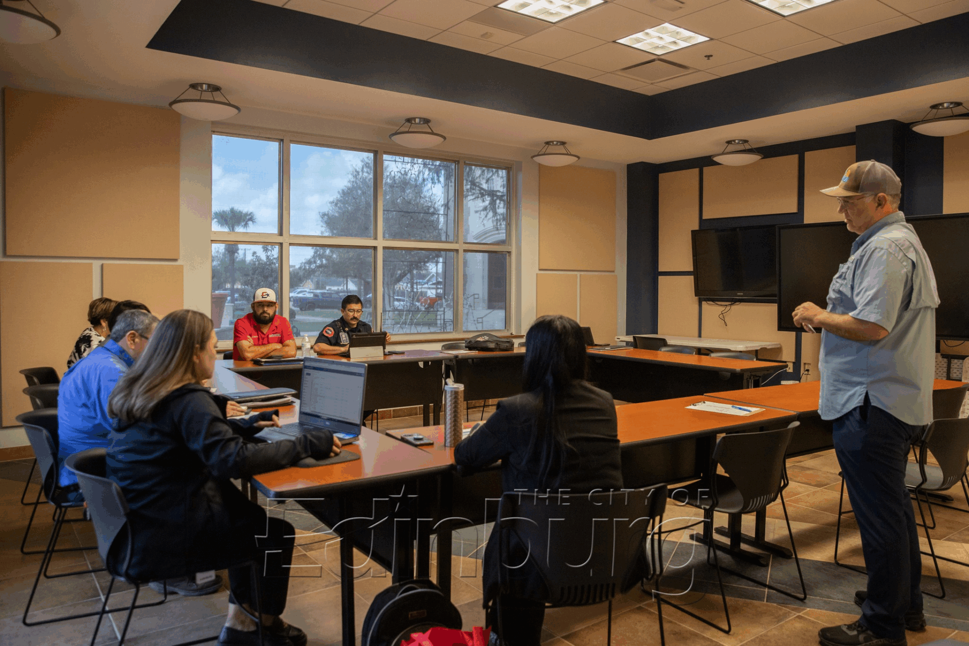 Instructor leading small meeting in conference room