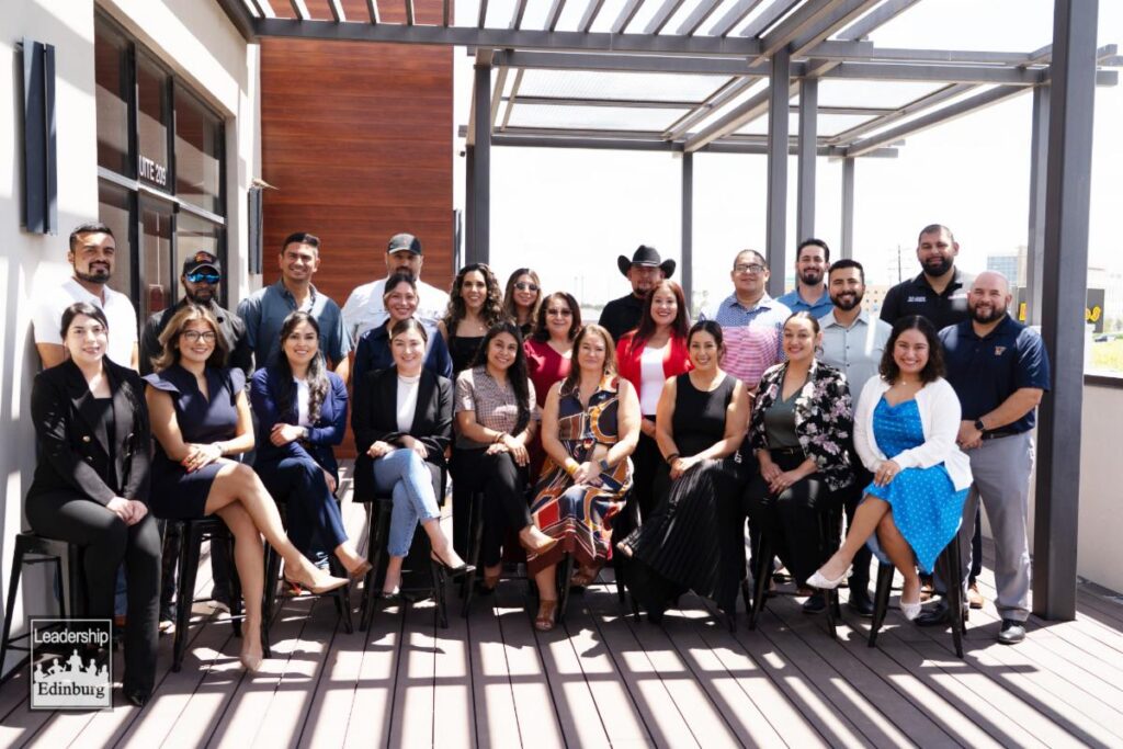 Group portrait of adults on rooftop terrace