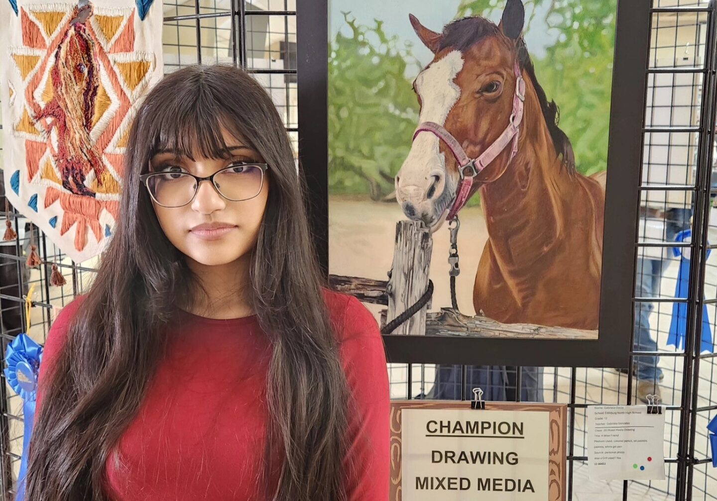 Artist standing next to champion horse painting