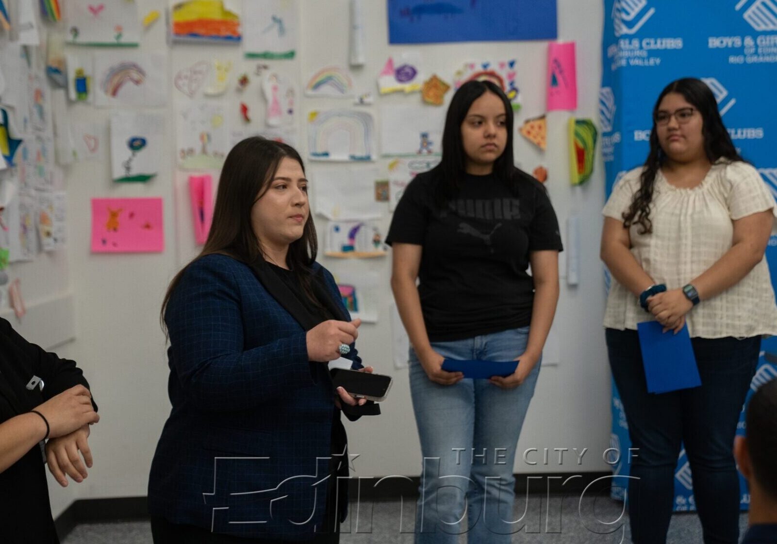Woman addressing teens at community center