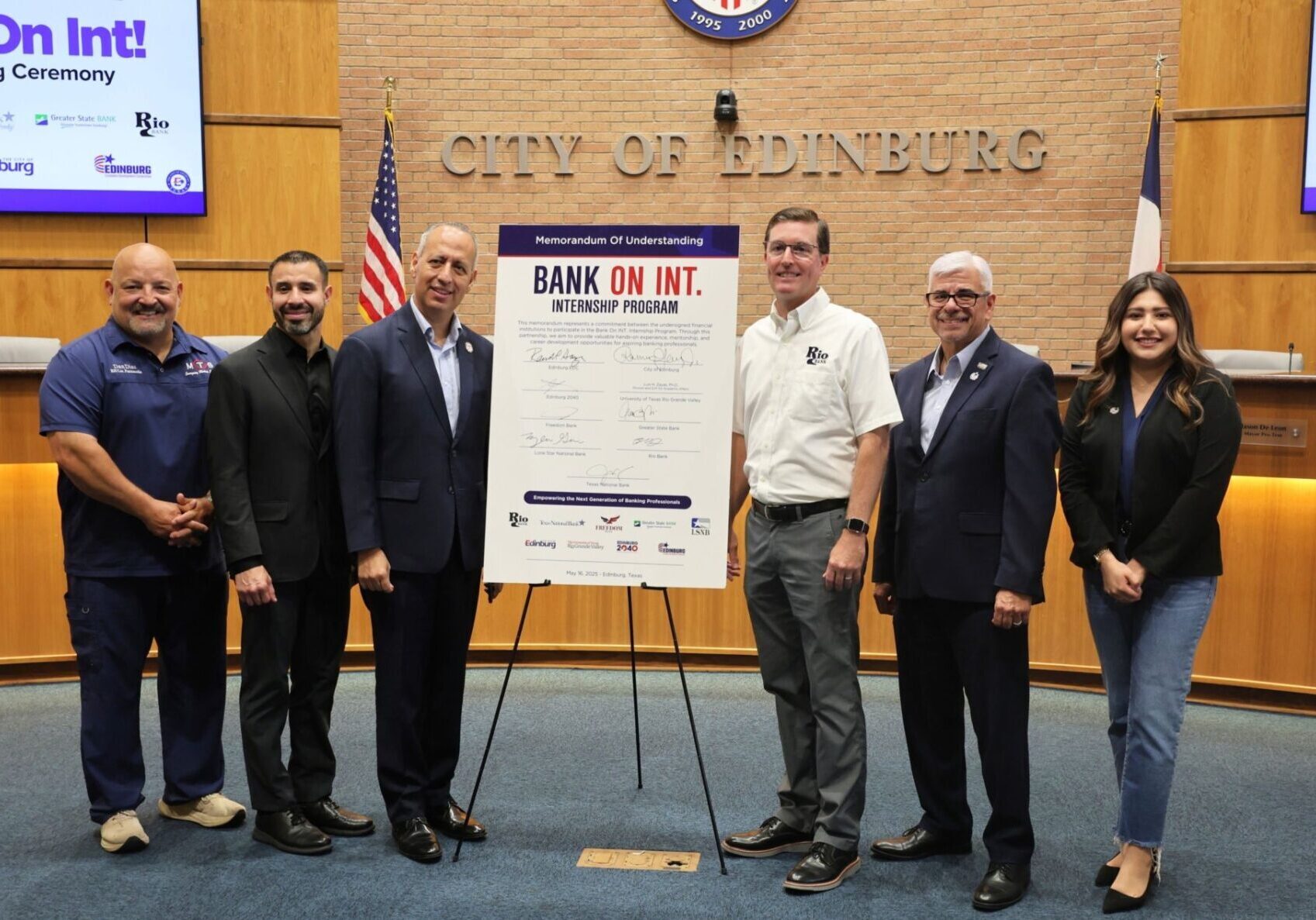 City officials posing with Bank On Int agreement