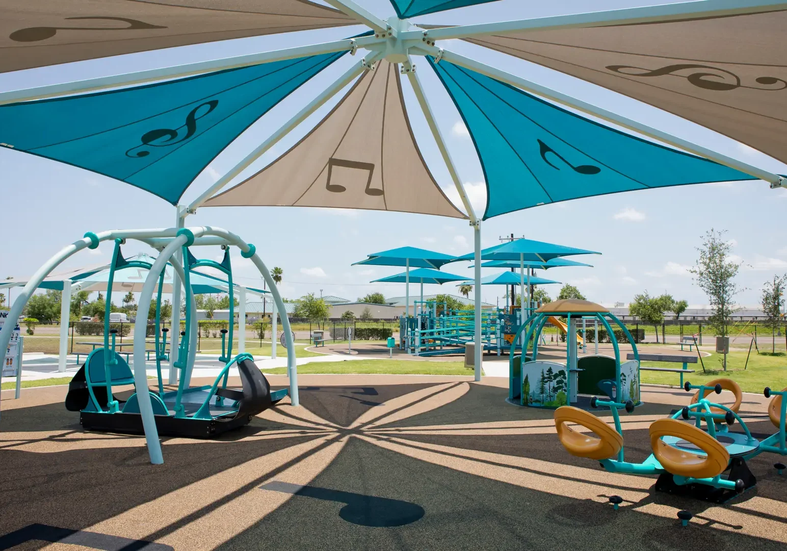 Modern shaded playground with teal equipment
