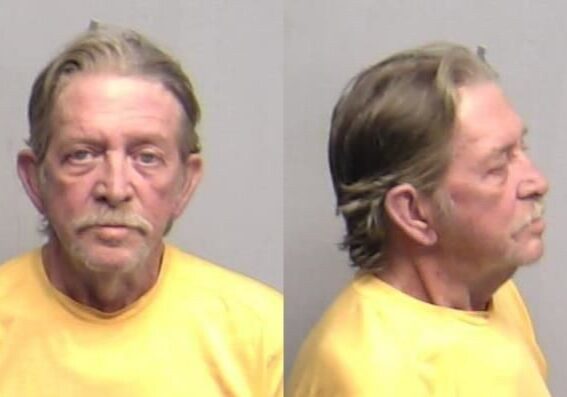 Mugshot of older man in yellow shirt