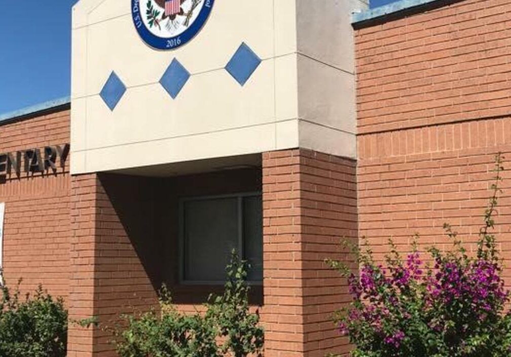 Brick elementary school building entrance with flowers
