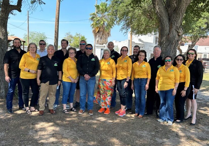 Group of people wearing yellow shirts under trees