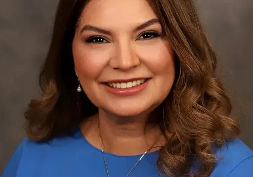Smiling headshot of woman in blue top