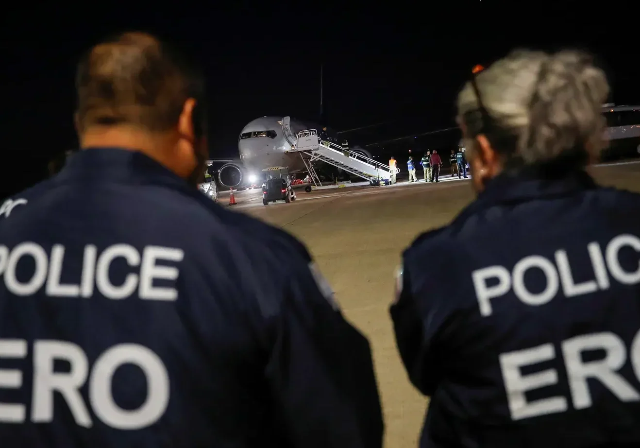 Police ERO officers watching airplane on tarmac