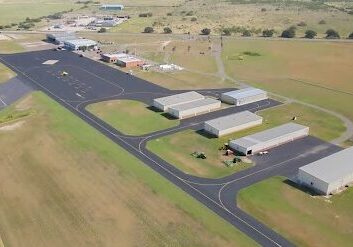 Aerial view of rural airport hangars and runway