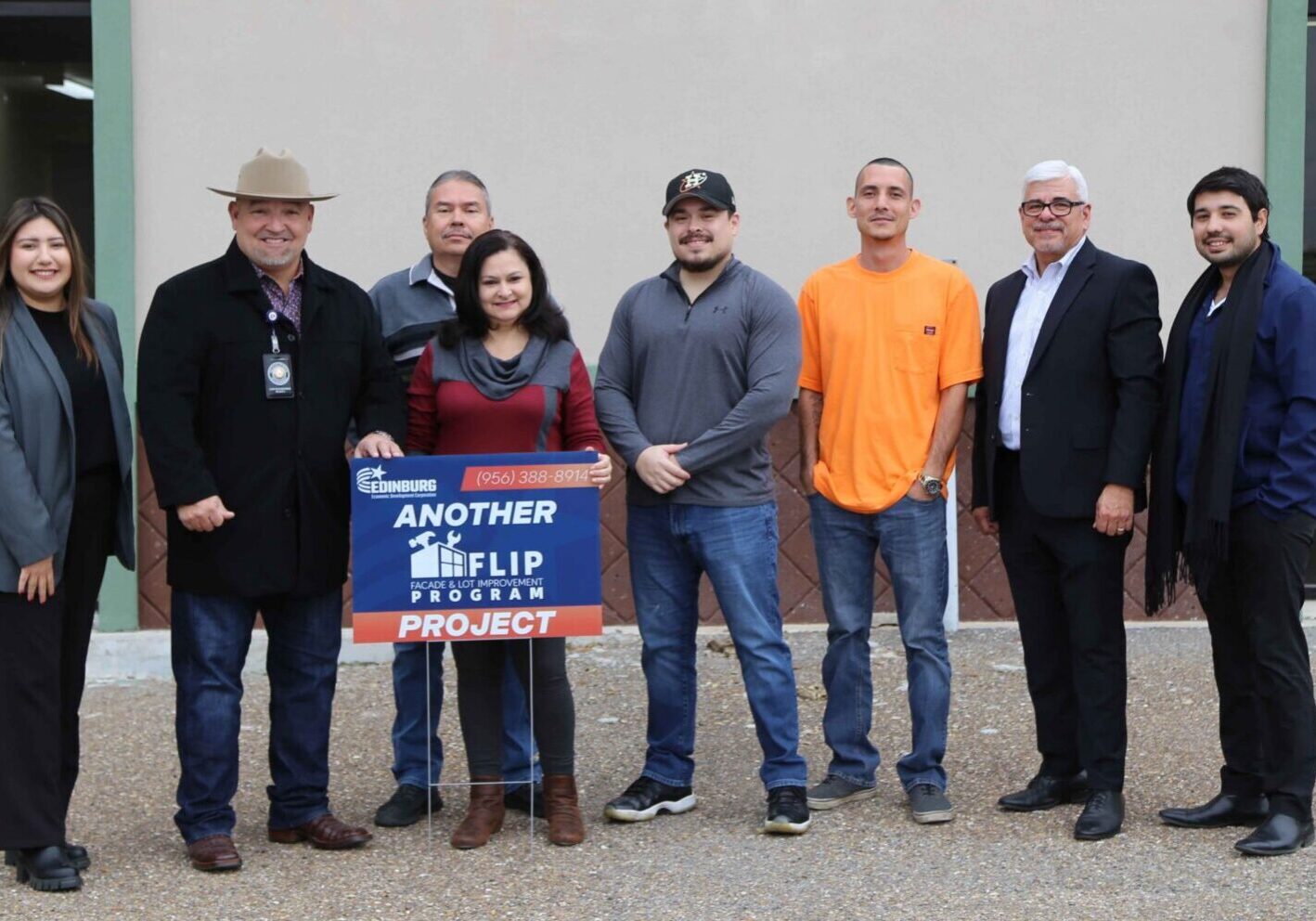 Group holding "Another Flip Project" sign