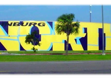 Yellow 'NORTH' mural with palm trees