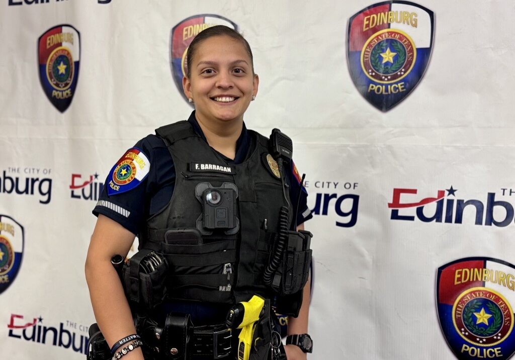 Smiling police officer wearing tactical vest