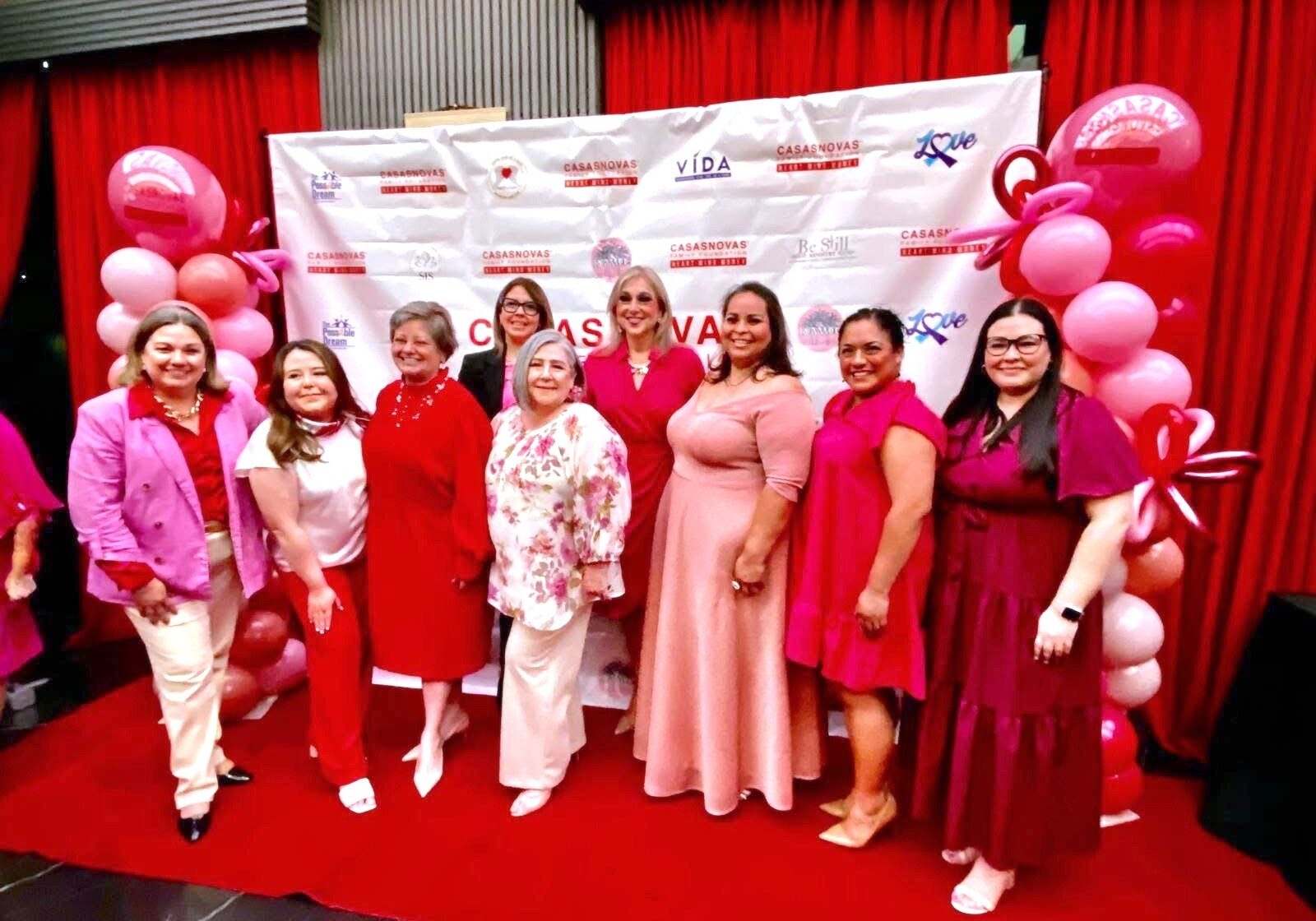 Group of women in pink dresses at event