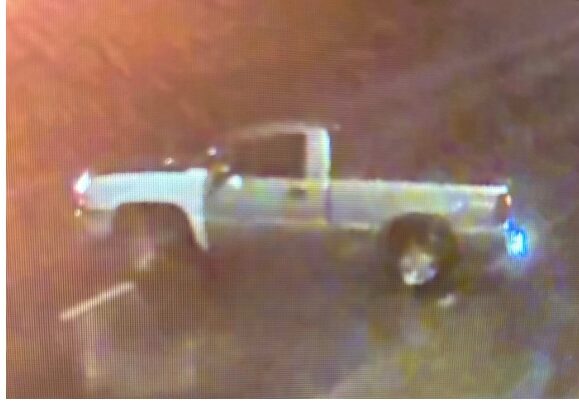White pickup truck parked at night