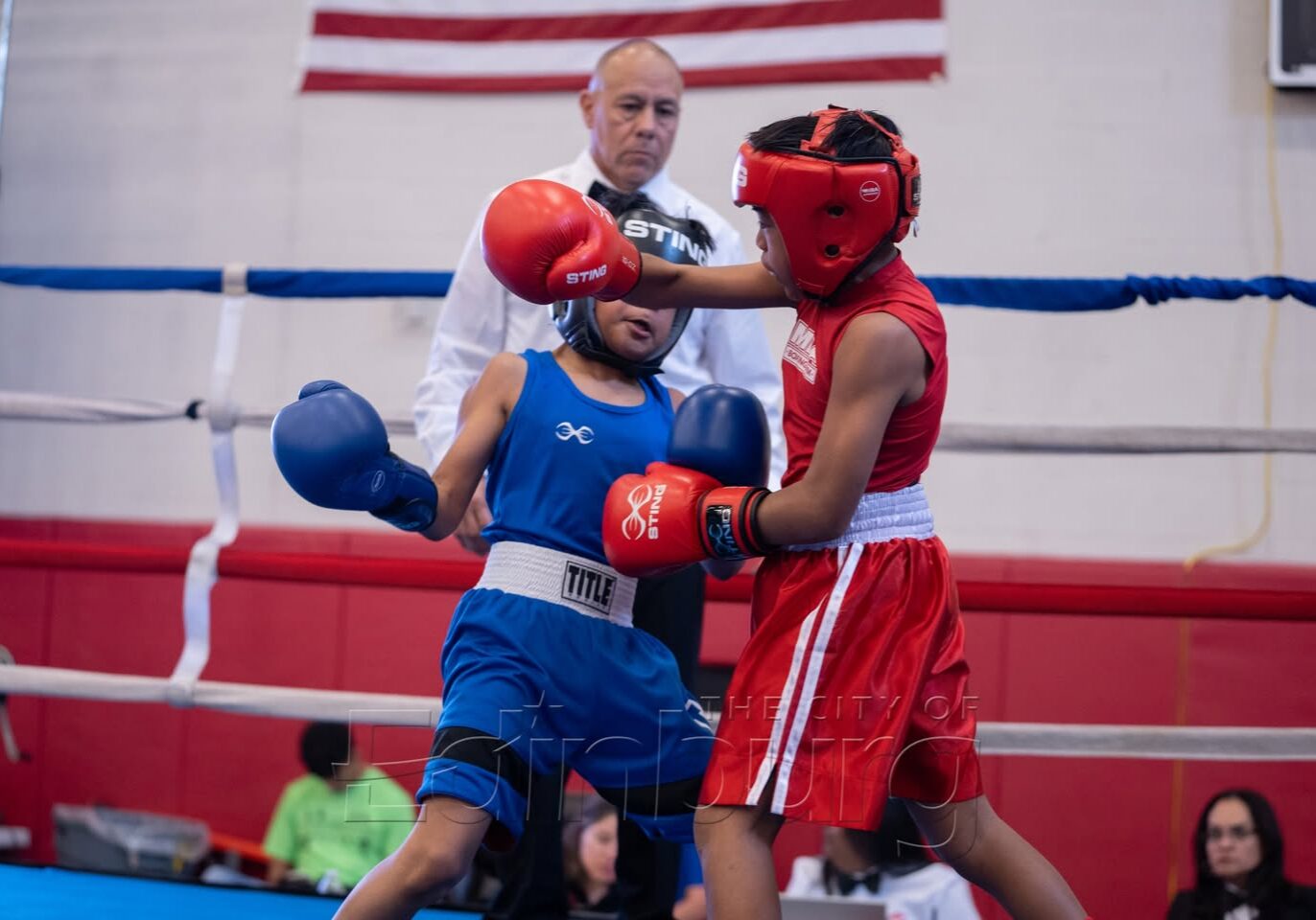 Youth boxer in red lands punch on blue