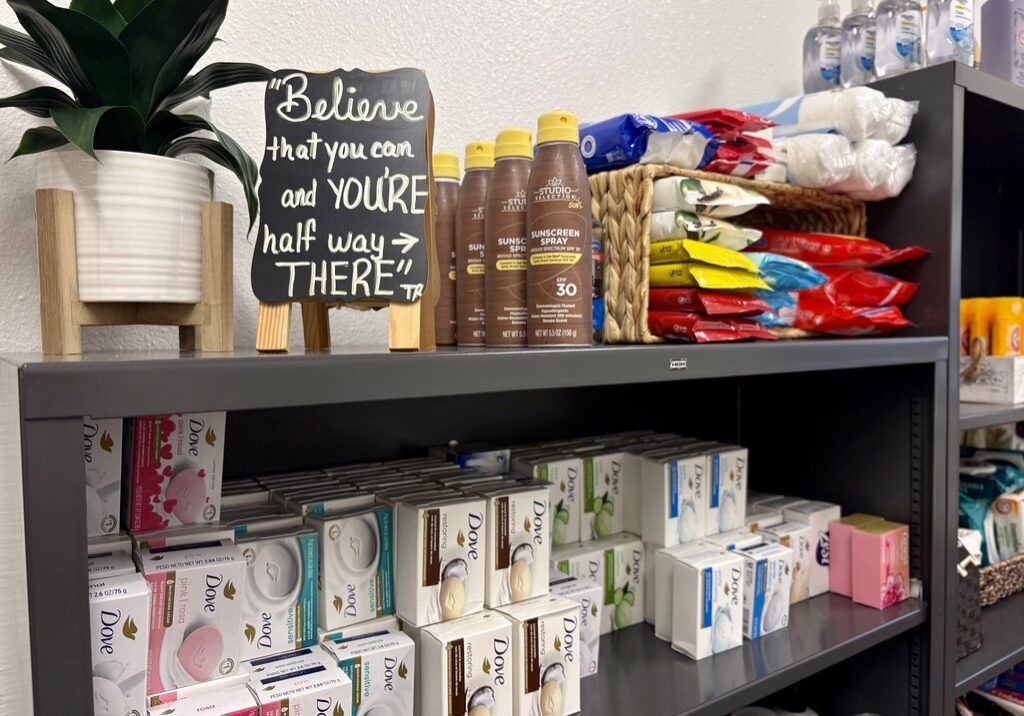 Shelf stocked with soap, snacks, and sunscreen