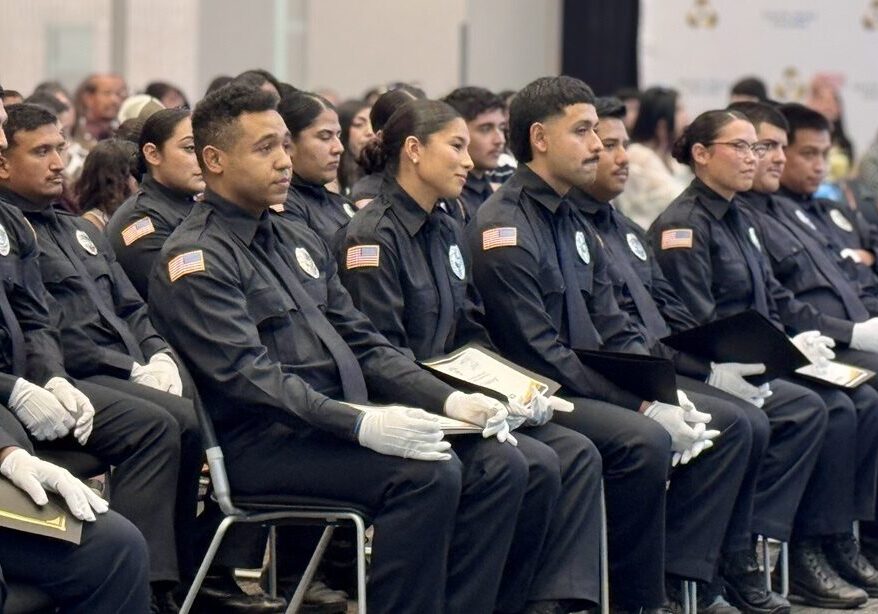 Line of uniformed officers seated at graduation