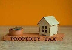 House model with tape measure, "Property Tax