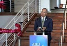 Man speaking at podium on staircase
