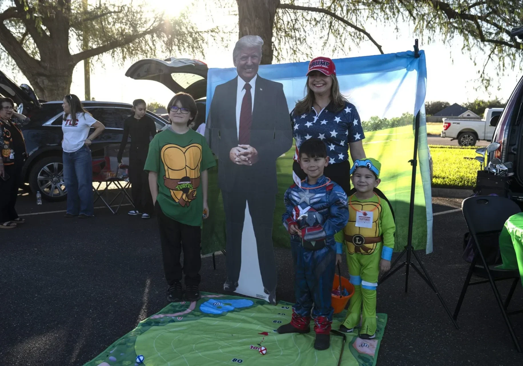 Children in costumes with cardboard cutout