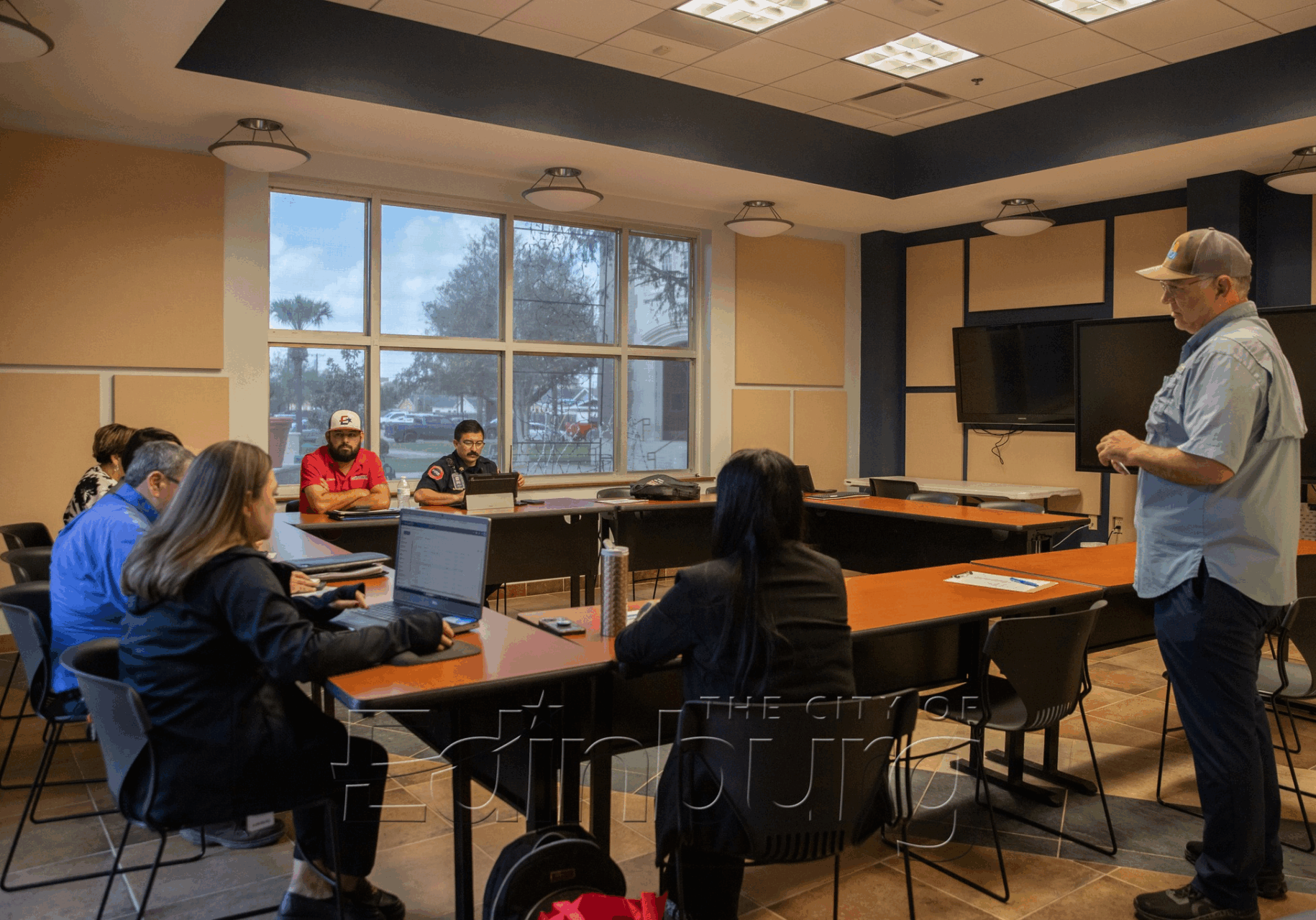 Instructor leading small meeting in conference room